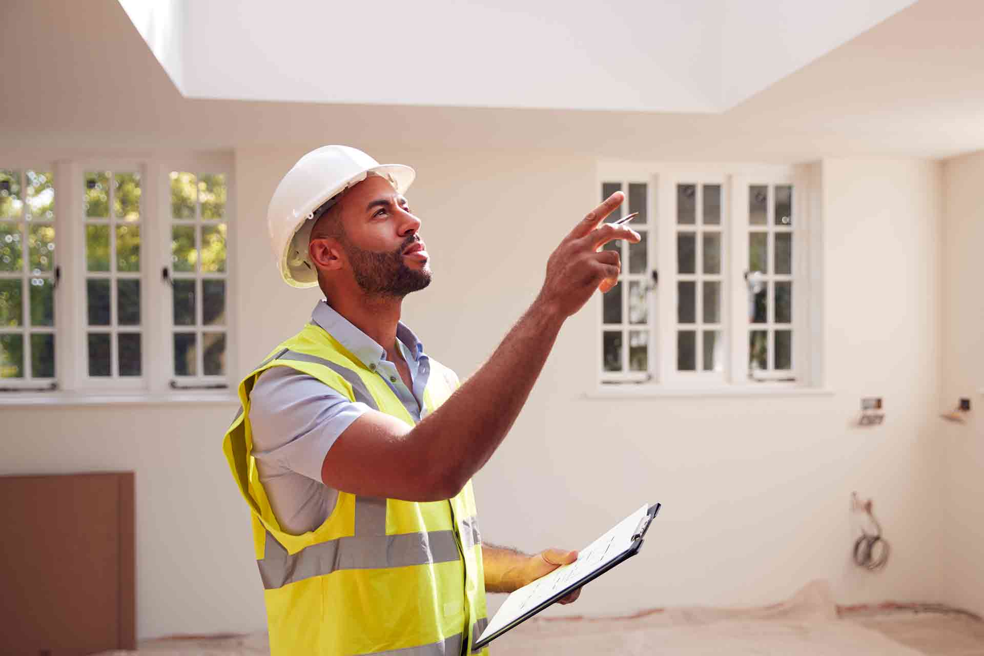 Third Party Wall Surveyors Wimbledon reviewing plans between two parties during a dispute